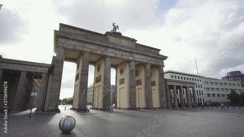 Slow movement of Branderburger Gate from behind in Berlin. Cloudy sky. photo