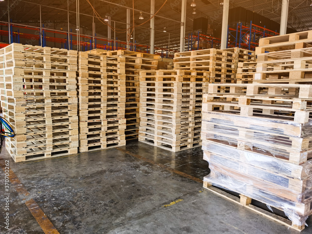 Worker driving forklift to loading and unloading wooden pallets from truck to warehouse cargo storage, shipment in logistics and transportation industrial, wood pallets stack Worker driving forklift to loading and unloading wooden pallets from truck to warehouse cargo storage, shipment in logistics and transportation industrial, wood pallets stack