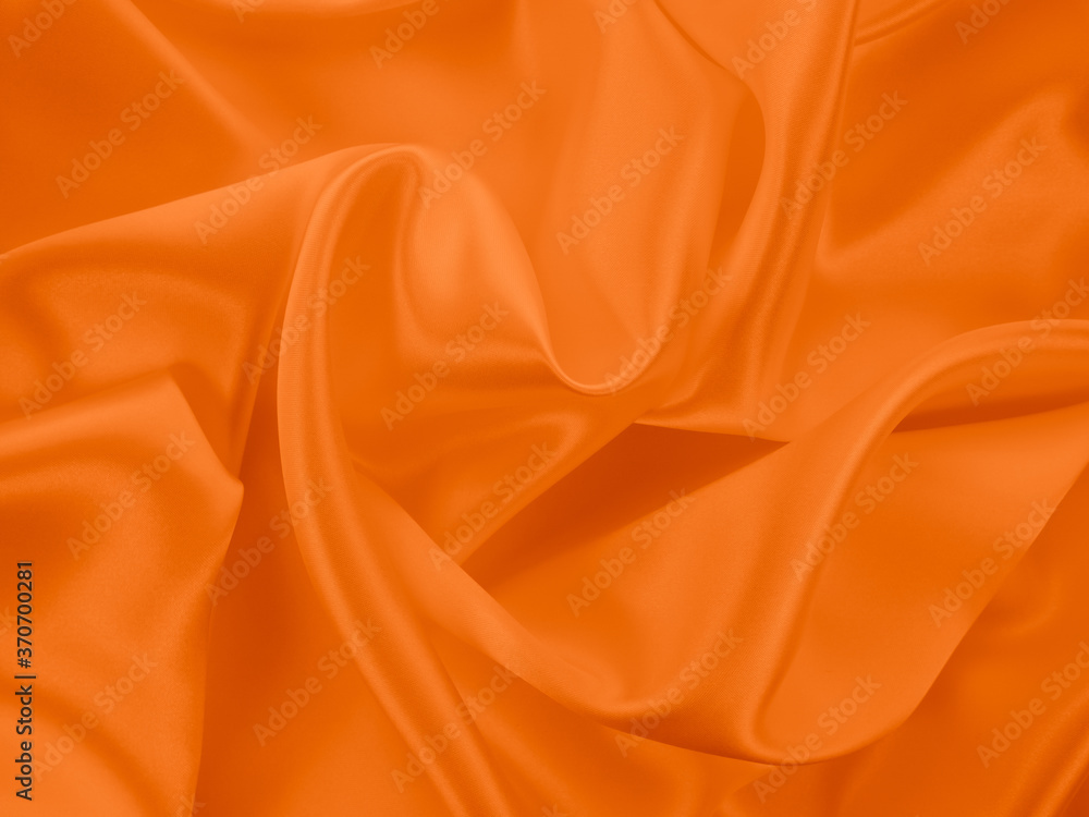 Beautiful elegant wavy orange satin silk luxury cloth fabric texture, abstract background design. Beautiful elegant wavy orange satin silk luxury cloth fabric texture, abstract background design.