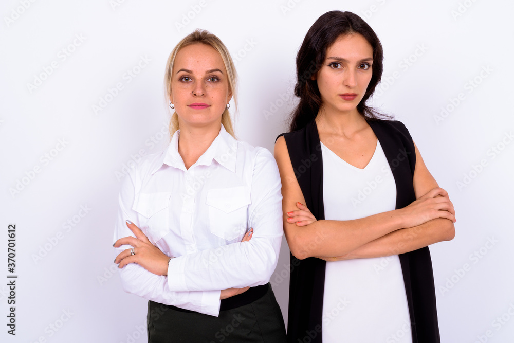 Portrait of two young beautiful businesswomen together Portrait of two young beautiful businesswomen together
