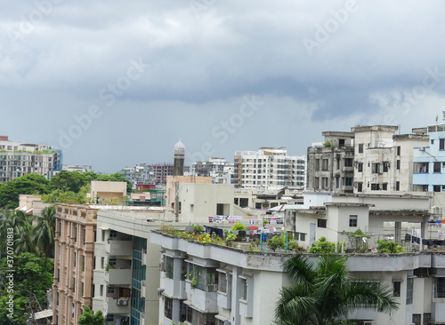 Townscape. Ancient architecture in the city of Dhaka, Bangladesh. View of the buildings, structures, and rooftops of the village under a dramatic cloudy sky.