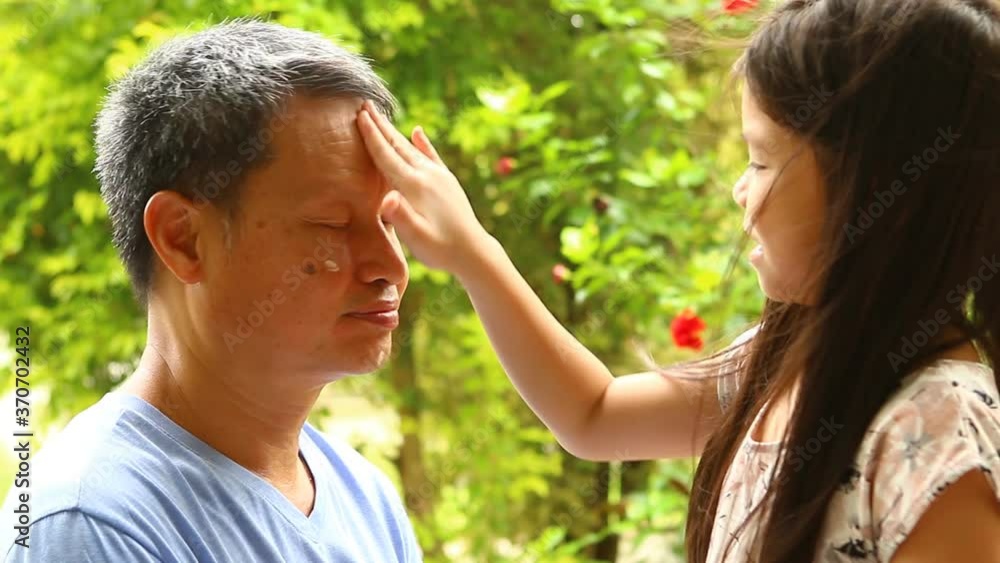 Thai little girl makeup her father face , out door Chiangmai Thailand Thai little girl makeup her father face , out door Chiangmai Thailand