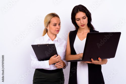 Portrait of two young beautiful businesswomen together