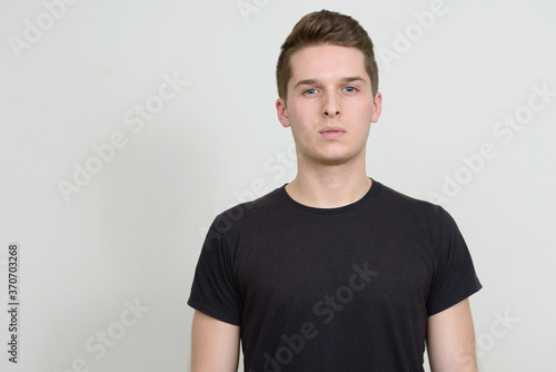 Portrait of young handsome man against white background © Ranta Images