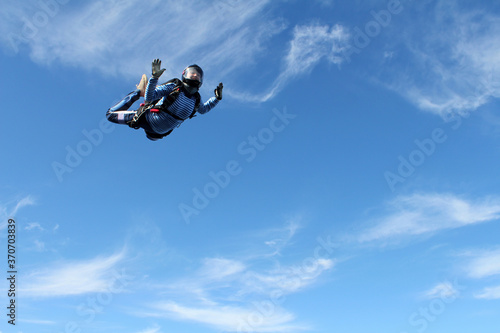 Skydiving. A military girl is flyingin the sky.