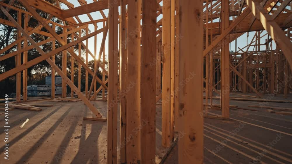 Sun shining through the framing of a new home construction. Sun shining through the framing of a new home construction.