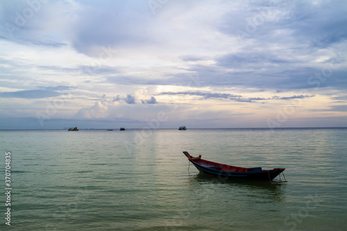 long tail boat at sunset on a beach in Koh Tao, Thailand © hectorchristiaen