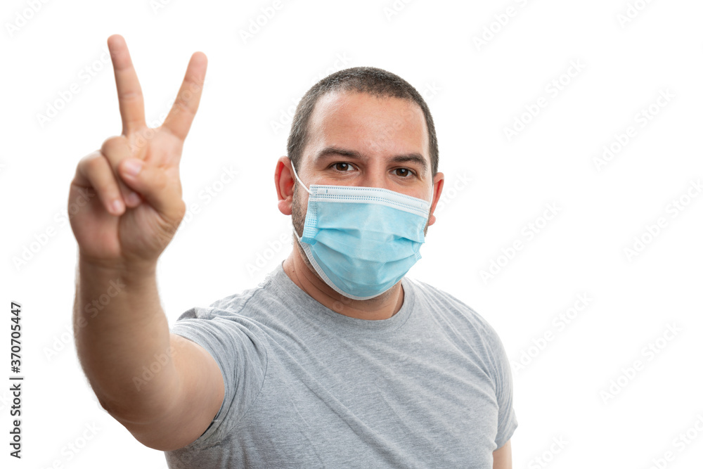 Man wearing mask making peace or victory sign with fingers Man wearing mask making peace or victory sign with fingers