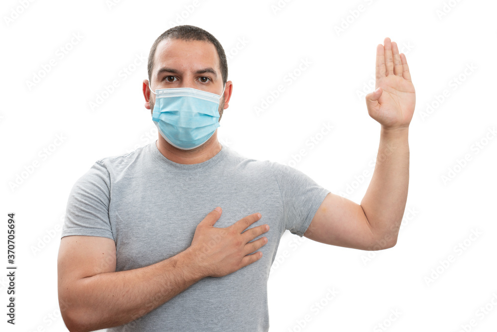 Man making oath gesture with hands wearing medical surgical mask Man making oath gesture with hands wearing medical surgical mask