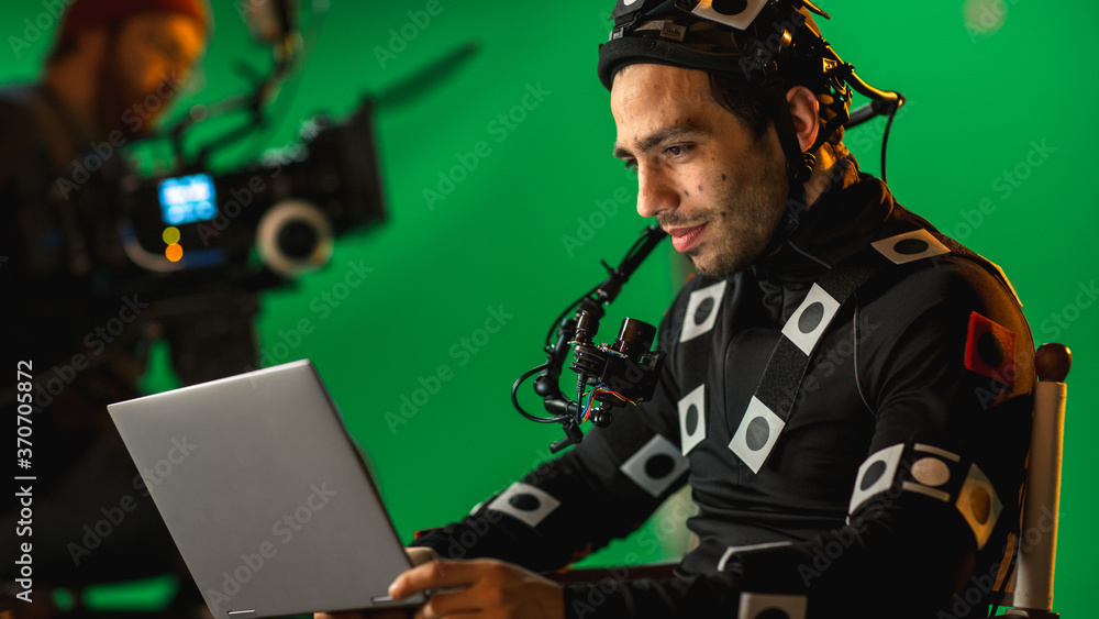 Handsome Smiling Actor Wearing Motion Capture Suit and Head Rig having