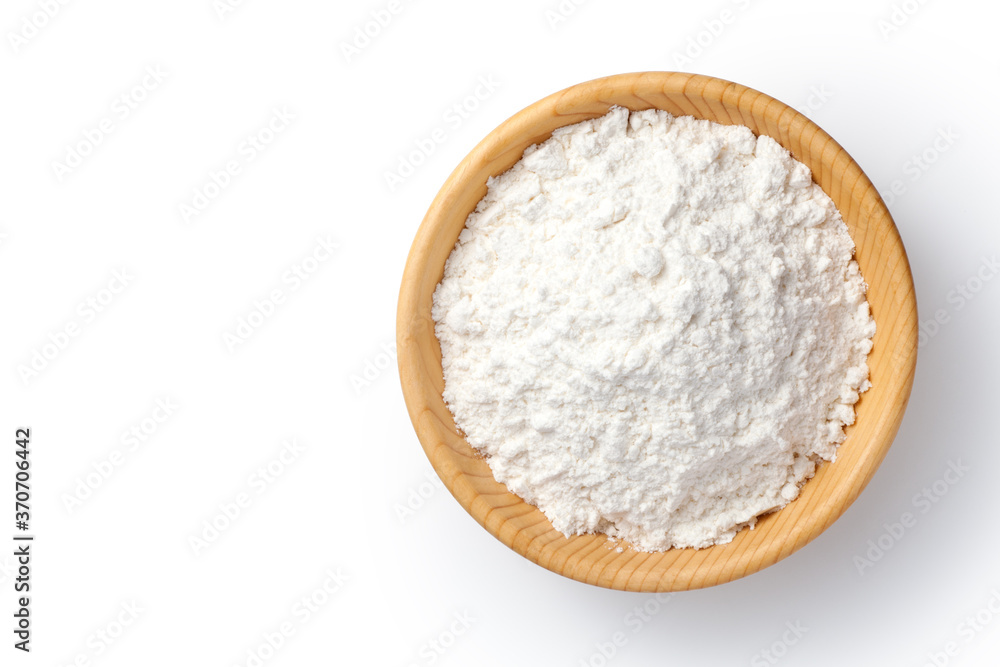 wheat flour in a wooden bowl isolated on white background. top view. wheat flour in a wooden bowl isolated on white background. top view.