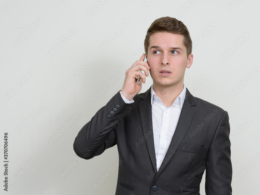 Portrait of young handsome businessman talking on the phone Portrait of young handsome businessman talking on the phone