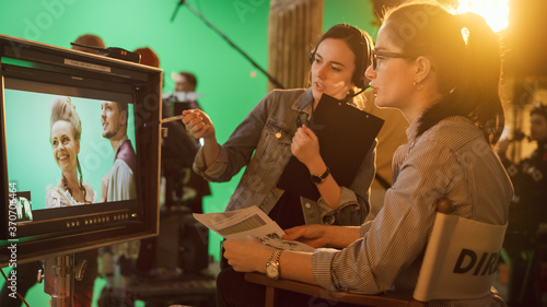 Foto Famous Talented Female Director in Chair Looks at Display talks with Assistant, Shooting Blockbuster