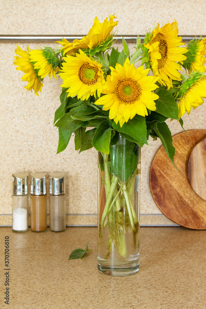 Autumn kitchen interior and bouquet of sunflowers on a stone countertop. Autumn kitchen interior and bouquet of sunflowers on a stone countertop.