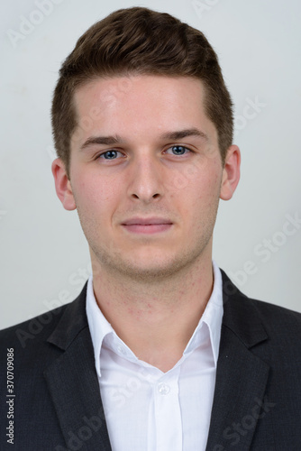 Portrait of young handsome businessman in suit