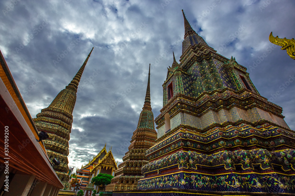 Fototapeta premium background of important religious attractions in Bangkok (Wat Phra Chetuphon (Wat Pho - reclining Buddha), a large pagoda and beautiful sculptural art give future generations to explore its history