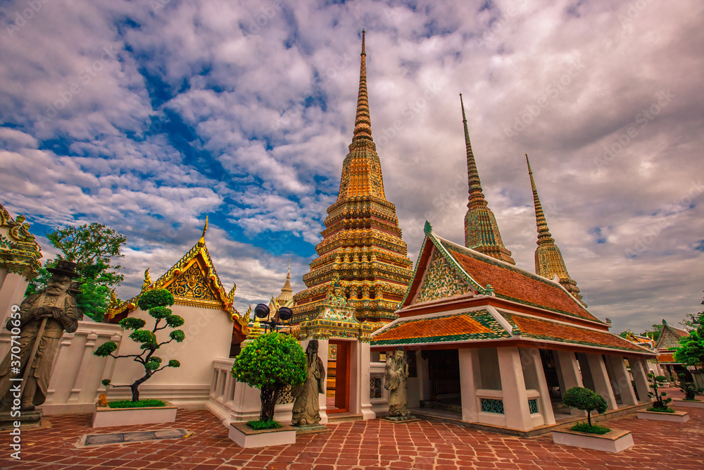 Fototapeta premium background of important religious attractions in Bangkok (Wat Phra Chetuphon (Wat Pho - reclining Buddha), a large pagoda and beautiful sculptural art give future generations to explore its history