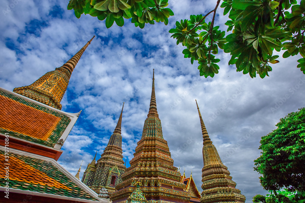 Fototapeta premium background of important religious attractions in Bangkok (Wat Phra Chetuphon (Wat Pho - reclining Buddha), a large pagoda and beautiful sculptural art give future generations to explore its history