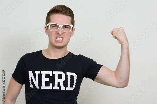 Portrait of young handsome nerd man with eyeglasses © Ranta Images