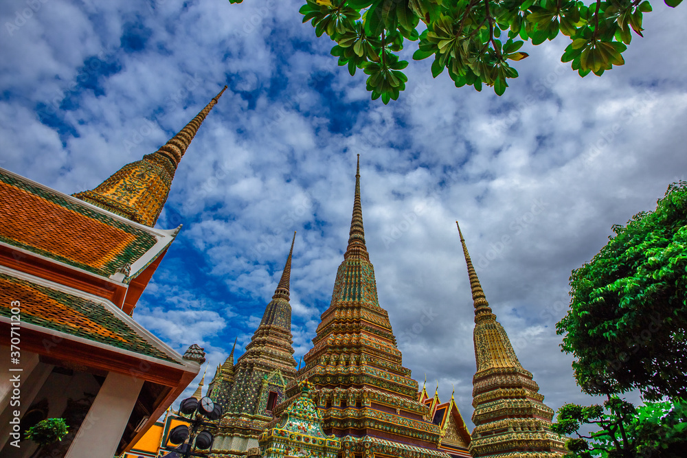 Fototapeta premium background of important religious attractions in Bangkok (Wat Phra Chetuphon (Wat Pho - reclining Buddha), a large pagoda and beautiful sculptural art give future generations to explore its history