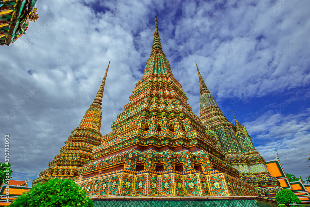 Fototapeta premium background of important religious attractions in Bangkok (Wat Phra Chetuphon (Wat Pho - reclining Buddha), a large pagoda and beautiful sculptural art give future generations to explore its history