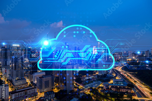 Information cloud hologram, aerial panoramic cityscape of Kuala Lumpur at night. The concept of secure storing digital data in KL, in Malaysia, Asia. Multi exposure.