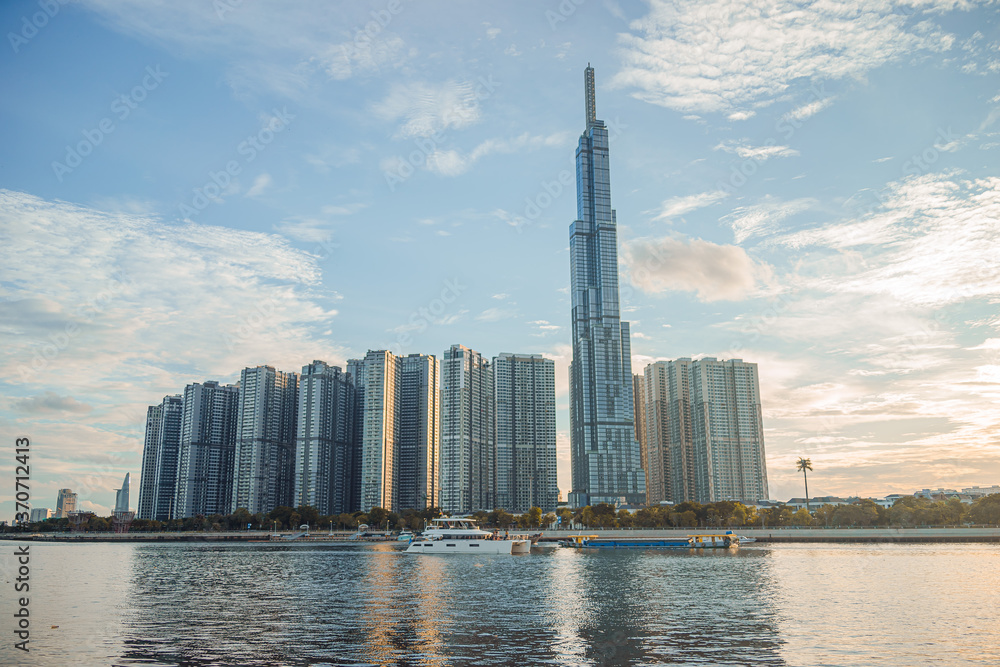 Fototapeta premium Beautiful blue sky view at Landmark 81 is a super tall skyscraper in center Ho Chi Minh City, Vietnam and Saigon bridge with development buildings, energy power infrastructure.