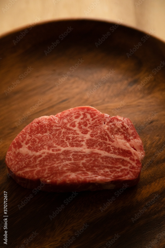 Beef fillet steak on the wooden plate Beef fillet steak on the wooden plate