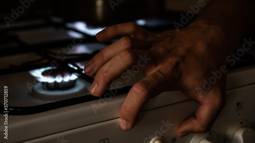 My hand on the kitchen cooker near the fire