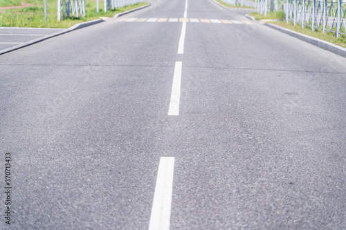 Sity  road  and road markings, focus to the foreground, blurred background