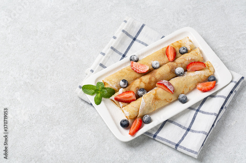 Delicious Tasty Homemade pancakes with strawberries and blueberries. Healthy Pancakes breakfast with fresh berries.