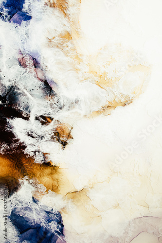 Marble texture. Ink water. Aerial seashore. Yellow sand blue ocean waves in white cloud abstract design. Land streak surface pattern art background. Luxury nature banner. © golubovy
