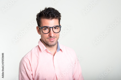 Portrait of young handsome Hispanic businessman against white background © Ranta Images