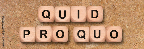 quid pro quo printed on wooden cubes photo