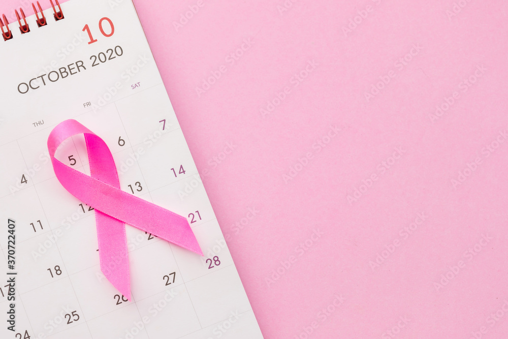 Breast Cancer concept : Top view pink ribbon and calendar symbol of breast cancer campaign on pink - obrazy, fototapety, plakaty 
