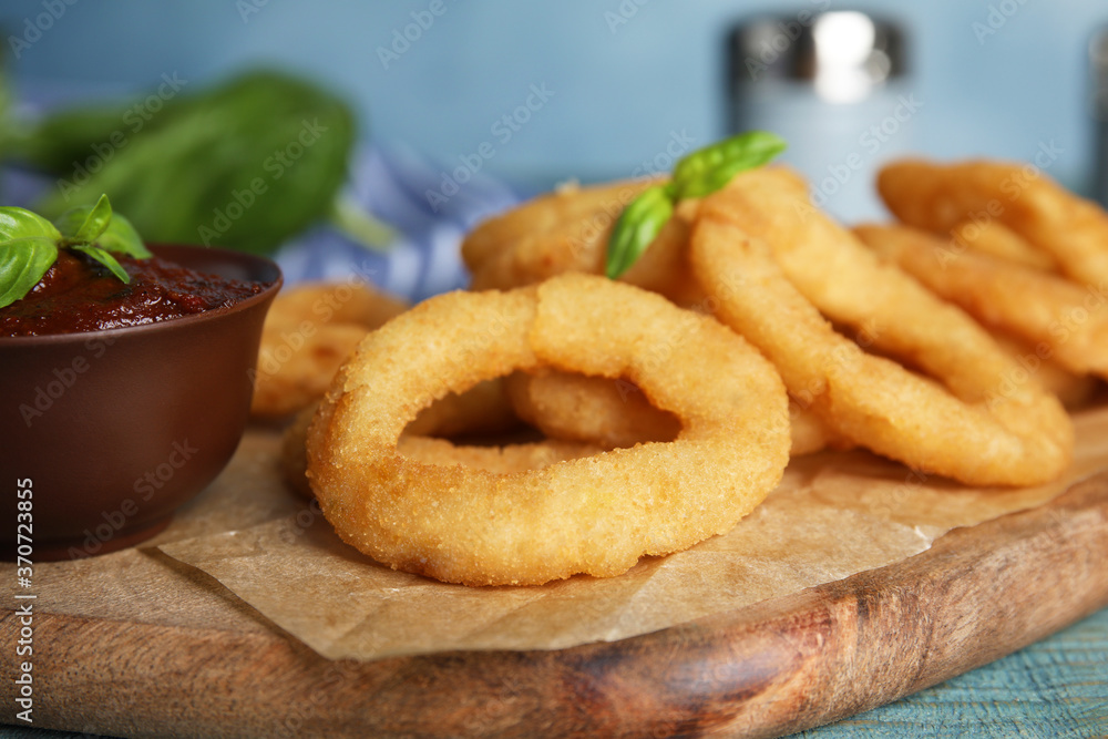 Fried onion rings served on blue wooden table, closeup Fried onion rings served on blue wooden table, closeup