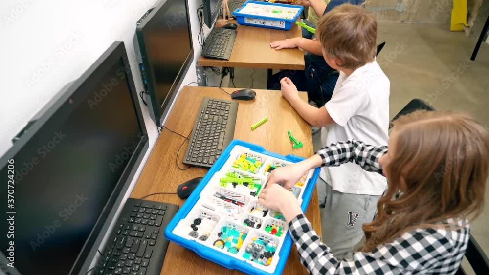 Kids making robot using building kit. Kids making robot using building kit.