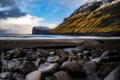 seascape with rocks in a small town near a mountain