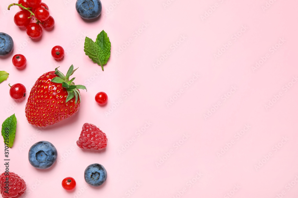 Naklejka Mix of fresh berries on pink background, flat lay. Space for text
