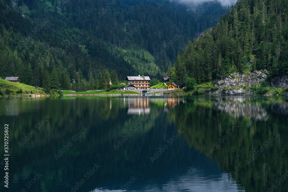 House and forest reflection in the mountain lake