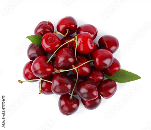 Tasty ripe red cherries with green leaves isolated on white, top view