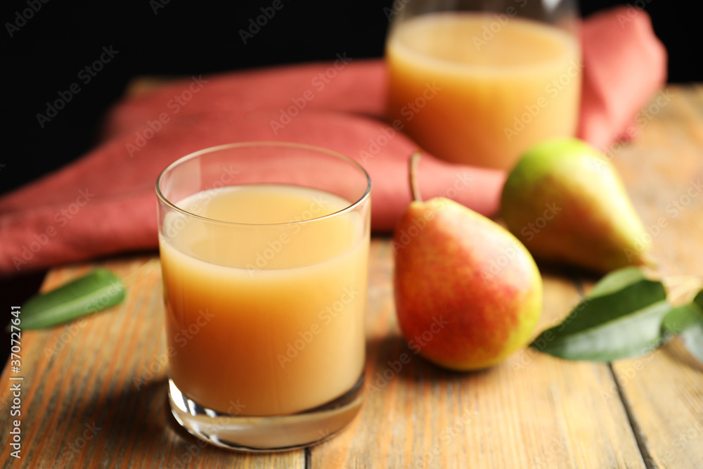 Fresh pear juice in glass and fruits on wooden table, closeup Fresh pear juice in glass and fruits on wooden table, closeup