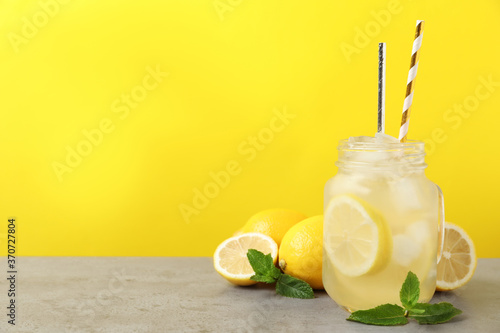 Natural freshly made lemonade with mint on light grey table. Summer refreshing drink