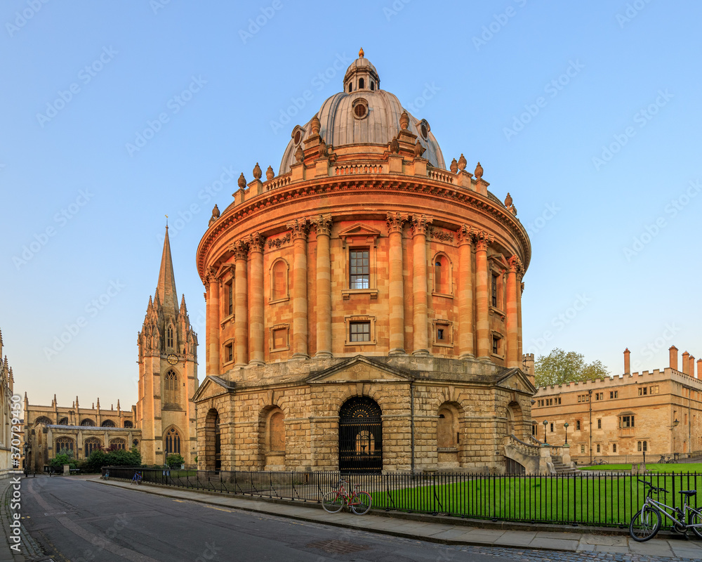 The Radcliffe Camera in Oxford at sunrise with no people around, early in the morning on a clear day with blue sky. Oxford, England, UK.