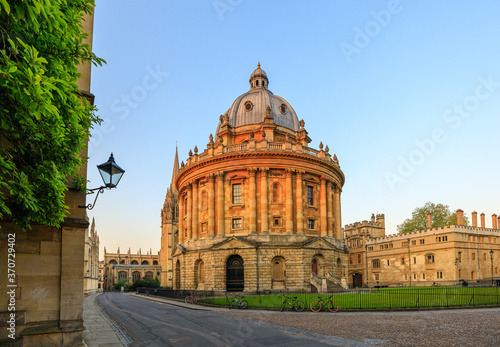 The Radcliffe Camera in Oxford at sunrise with no people around, early in the morning on a clear day with blue sky. Oxford, England, UK. photo