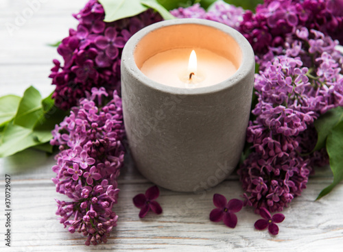 Candle and lilac flowers