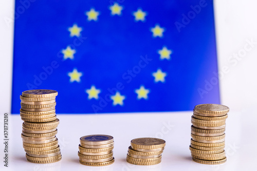 Coins with the Europe blue and yellow flag at the background, economy of europe