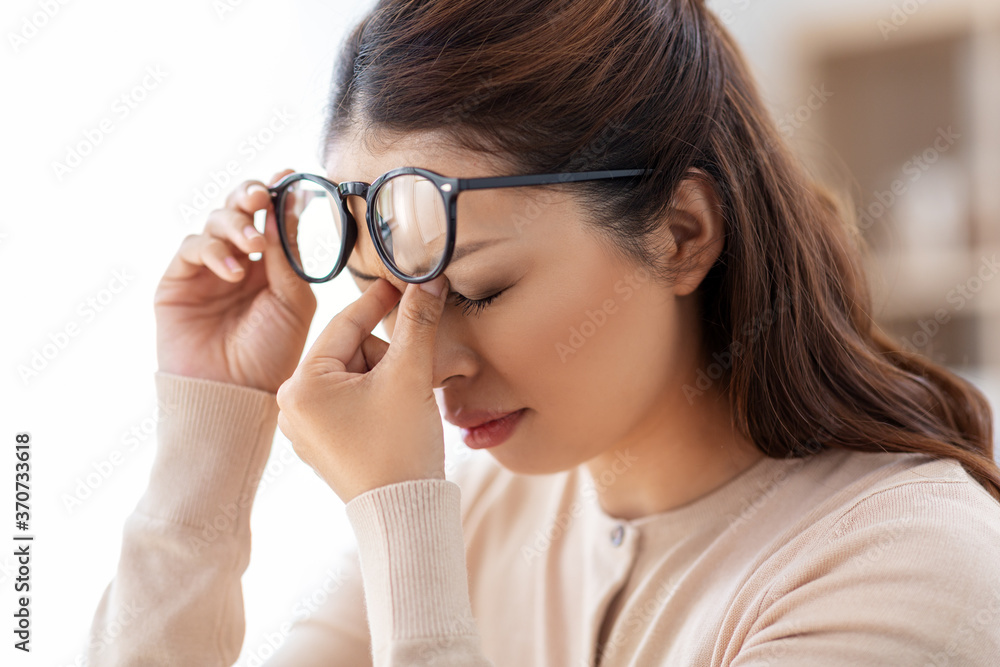 vision, stress and people concept - close up of tired asian woman with glasses rubbing her nose bridge vision, stress and people concept - close up of tired asian woman with glasses rubbing her nose bridge