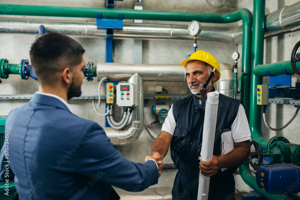 industry workers handshake in plant industry workers handshake in plant