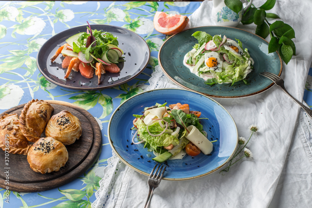 three different salads and bread bun for the menu on the table three different salads and bread bun for the menu on the table